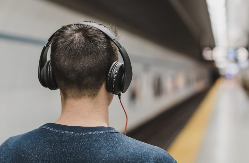  Man listening to music with headphones (Illustrative) (photo credit: STOCKSNAP)