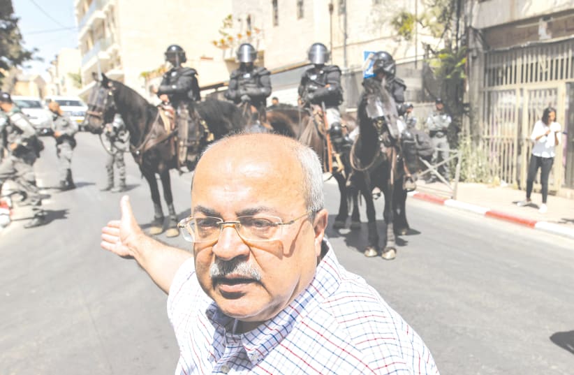  MK AHMAD TIBI (Joint List) stands near Israeli mounted police outside the Jerusalem District Court last year, during a protest over Israel’s planned evictions of Arab families from homes in Silwan. (photo credit: (AHMAD GHARABLI/AFP VIA GETTY IMAGES))