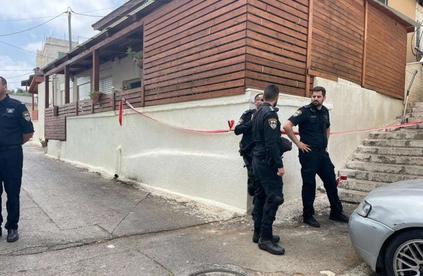  Police are seen outside a residency in Haifa where a husband and wife were found in critical condition, on June 12, 2022. (photo credit: MDA SPOKESPERSON)