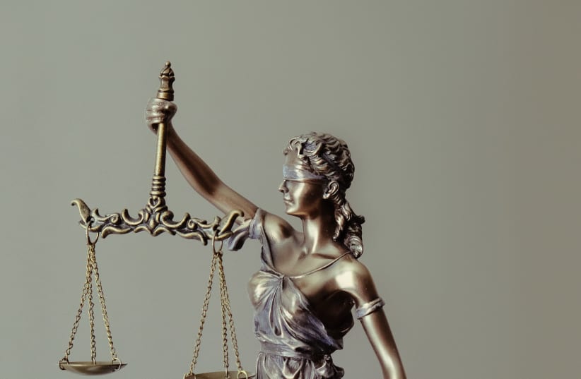  LADY JUSTICE: I tried to understand why this court case became such an obsession for half of the world. (photo credit: Tingey Injury Law Firm/Unsplash)