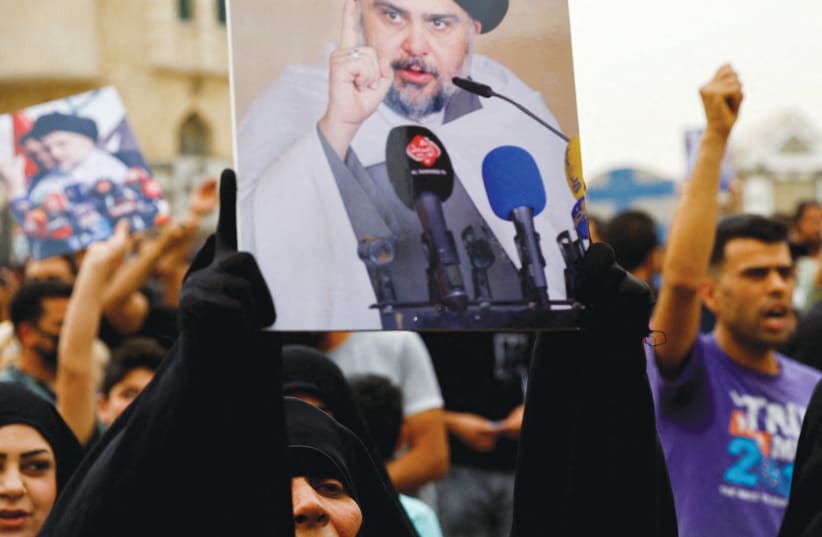  SUPPORTERS OF Iraqi Shi’ite Muslim cleric Muqtada al-Sadr shout slogans during a celebration after Iraq’s parliament passed a law criminalizing normalizing relations with Israel, in Baghdad last month. (photo credit: THAIER AL-SUDANI/REUTERS)