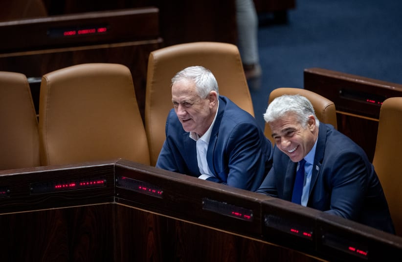  Foreign Affairs Minister Yair Lapid and Defense Minister Benny Gantz  seen during plenum session in the assembly hall of the Israeli parliament, in Jerusalem on June 20, 2022.   (photo credit: YONATAN SINDEL/FLASH90)