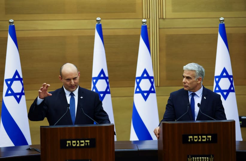  Israeli Prime Minister Naftali Bennett and Foreign Minister Yair Lapid give a statement at the Knesset, Israel's parliament, in Jerusalem, June 20, 2022. (photo credit: REUTERS/Ronen Zvulun)
