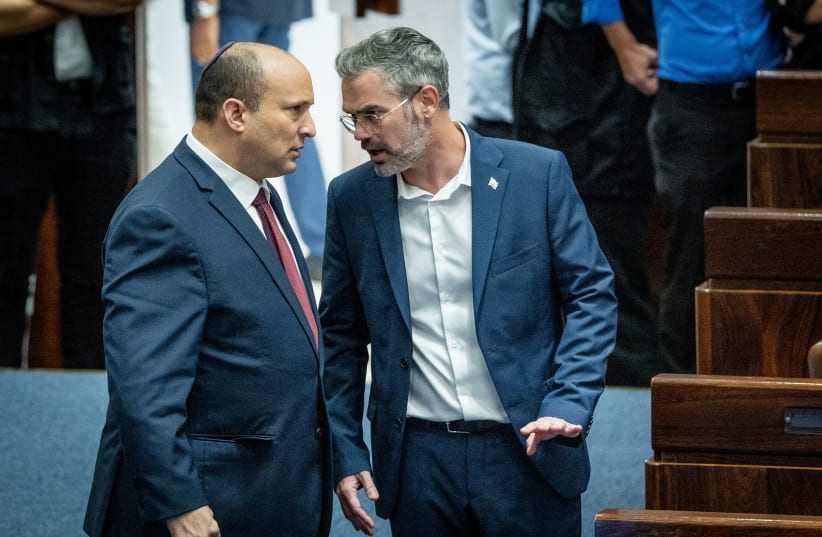  Israeli Prime Minister Naftali Bennett with Yesh Atid MK Boaz Toporovsky during a discussion and vote on the "Minimum Wage bill" at the Knesset, Jerusalem, on June 8, 2022. (photo credit: YONATAN SINDEL/FLASH90)