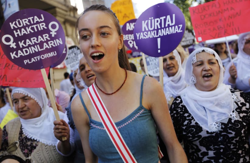  Demonstrators shout slogans as they march with placards during a protest against the government's plans on a new abortion law, in Istanbul June 17, 2012. (photo credit: REUTERS/MURAD SEZER)