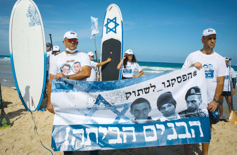  Surfers participate in a protest in Ashdod in June 2020 calling for the release of the Israelis and the bodies of IDF soldiers being held captive by Hamas. At the time, Hisham al-Sayed’s family did not want publicity.  (photo credit: OLIVIER FITOUSSI/FLASH90)