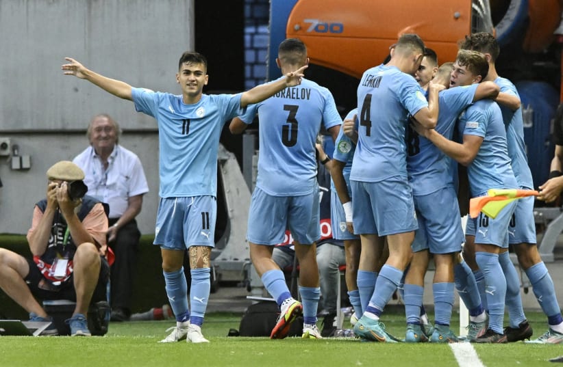  ISRAEL TEAMMATES celebrate a goal by Oscar Gloukh that, at the time, gave the blue-and-white a 1-0 lead in what ended as a 3-1 loss to England in the Under-19 European Championship final in Trnava, Slovakia. (photo credit: REUTERS/RADOVAN STOKLASA)