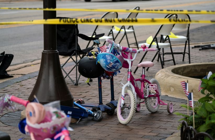  A child's bike is left behind after a mass shooting at a Fourth of July parade route in the wealthy Chicago suburb of Highland Park, Illinois, US July 4, 2022.  (photo credit: REUTERS/Max Herman)