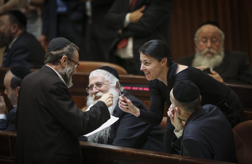  Members of Knesset in the assembly hall of the Israeli parliament during a vote on expanding the number of ministers in the new forming Israeli government on May 13, 2015. (photo credit: HADAS PARUSH/FLASH90)