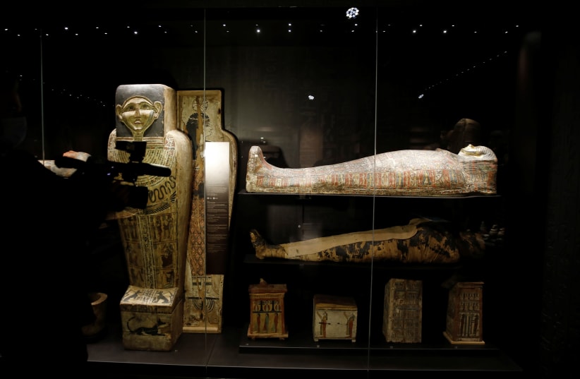  A cameraman films the only known example of a pregnant Egyptian mummy, displayed at an exhibition in National Museum in Warsaw, Poland May 4, 2021 (photo credit: REUTERS/KACPER PEMPEL)