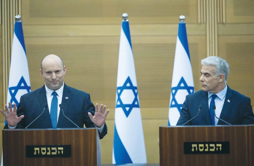  NAFTALI BENNETT and Yair Lapid hold a press conference at the Knesset last month, where they announced that they will be switching their positions as prime minister and alternate prime minister as the country goes to a new election.  (photo credit: YONATAN SINDEL/FLASH90)