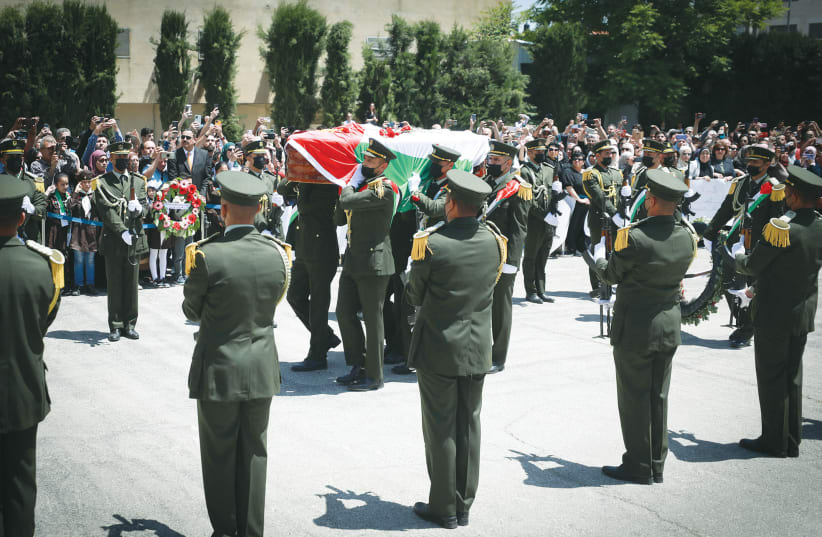  PA HONOR GUARDS carry the casket of Al Jazeera journalist Shireen Abu Akleh, at a ceremony in Ramallah, in May. (photo credit: FLASH90)