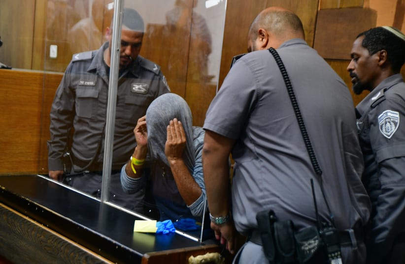  A man, suspected of murdering a 60-year-old man yesterday in Ramat Gan, arrives for a court hearing at the Tel Aviv Magistrate's Court on June 19, 2022 (photo credit: AVSHALOM SASSONI/FLASH90)
