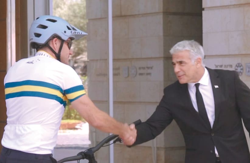  THE AMBASSADOR meets at the final stage of his bike trek with Prime Minister Yair Lapid outside the Foreign Ministry in Jerusalem, before Lapid became premier. (photo credit: JORDAN POLEVOY PHOTOGRAPHY)