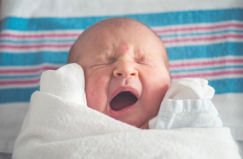  Crying baby. What are some tips for caring for newborns? (Illustrative). (photo credit: Tim Bish/Unsplash)