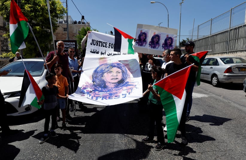  Palestinians protest in support of slain Palestinian-American journalist Shireen Abu Akleh, as US President Joe Biden visits Augusta Victoria Hospital, in Jerusalem July 15, 2022.  (photo credit: REUTERS/AMMAR AWAD)