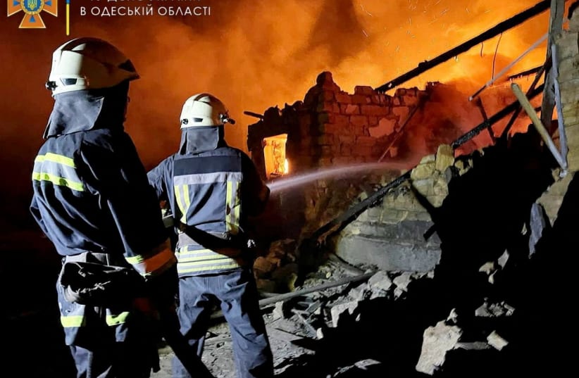  Firefighters work at a scene after a shelling, as Russia's invasion of Ukraine continues in a location given as Odesa, Ukraine in this picture obtained from social media released on July 19, 2022. (photo credit: STATE EMERGENCY SERVICES/HANDOUT VIA REUTERS)