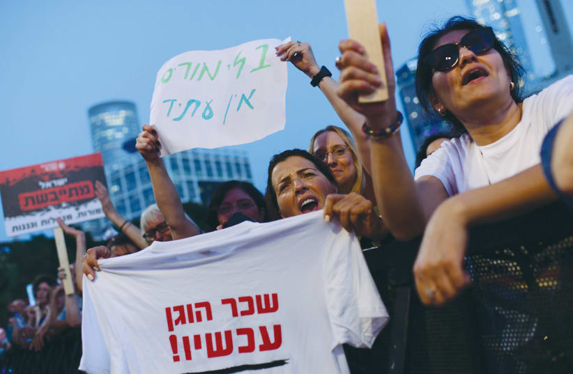  TEACHERS DEMAND better pay and working conditions, as they demonstrate in Tel Aviv, in May. A sign reads: ‘Without teachers, there is no future.’ The shirt reads: ‘Fair salary now!’ (photo credit: TOMER NEUBERG/FLASH90)