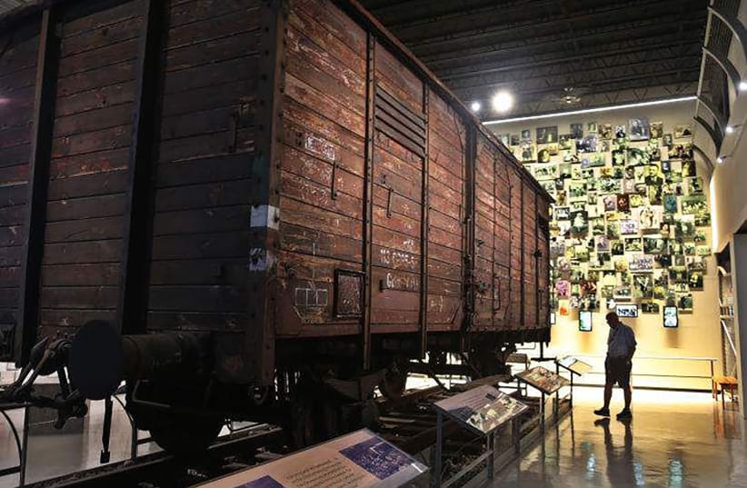  A visitor at the Florida Holocaust Museum in St. Petersburg, Florida, examines a box car used by the Nazi's to transport Jews to the death camps. The Florida Holocaust Museum sharply condemned demonstrations Saturday, July 23, 2022, at the Tampa Convention Center where a group of neo-fascists waved (photo credit: TAMPA BAY TIMES/TNS)