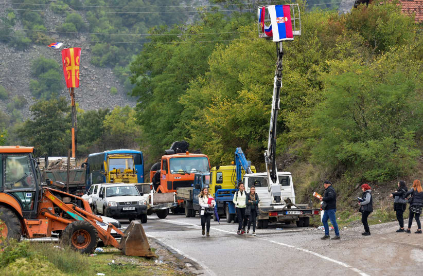  Kosovo ethnic Serbs pass through barricades near the border crossing between Kosovo and Serbia in Jarinje, Kosovo, September 28, 2021. (photo credit: REUTERS/LAURA HASANI)