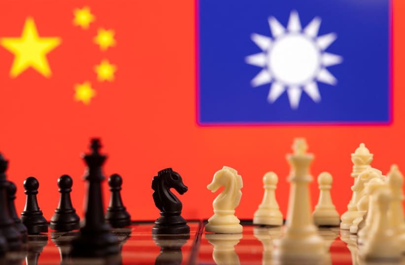 Chess pieces are seen in front of displayed China and Taiwan's flags in this illustration taken January 25, 2022.  (photo credit: REUTERS/DADO RUVIC/ILLUSTRATION)