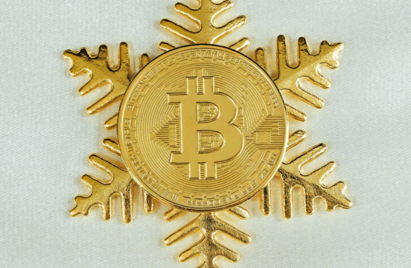 A gold Bitcoin on top of a gold snowflake (photo credit: UNSPLASH)