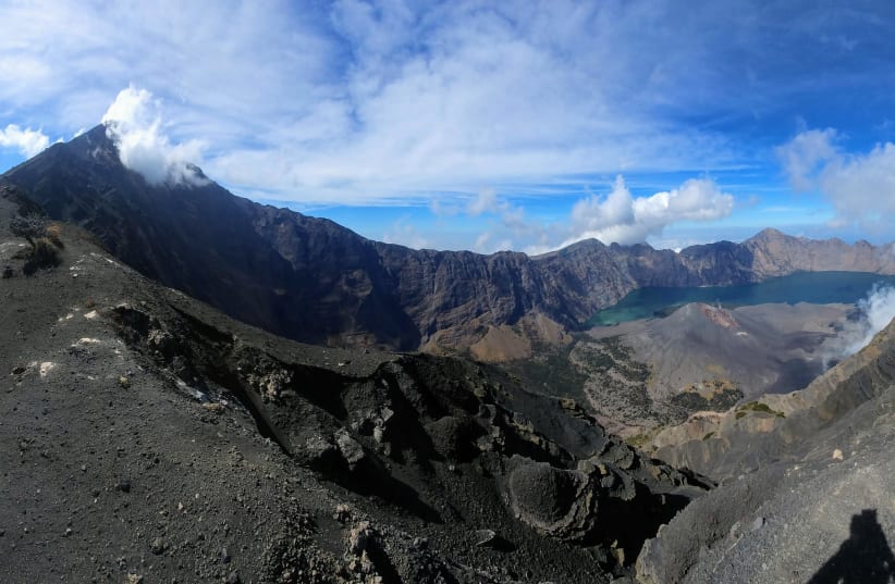  This panorama of Mount Rinjani and its summit, crater, and ash cone, was taken from an altitude of about 2,600 meters. (photo credit: Wikimedia Commons)