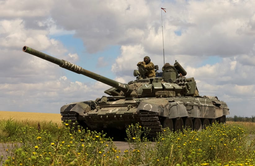 A tank of Russian troops drives in Russian-held part of Zaporizhzhia region, Ukraine, July 23, 2022. (photo credit: REUTERS/Alexander Ermochenko/File Photo)