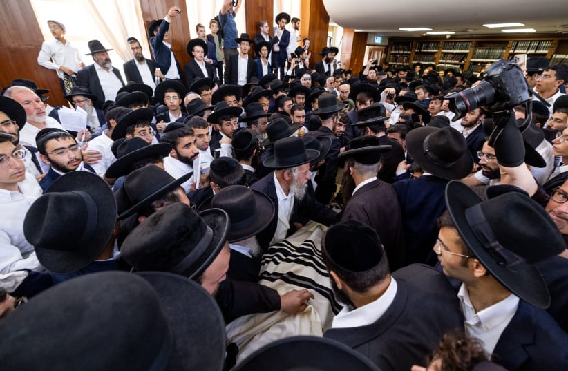  Ultra-Orthodox (haredi) Jewish men carrying the body of rabbi Shalom Cohen, head of the Purat Yosef yeshiva, and the spiritual leader of Shas during his funeral at a synagogue in Jerusalem on August 22, 2022 (photo credit: YONATAN SINDEL/FLASH90)