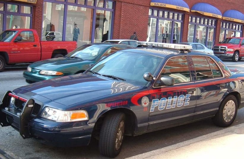 An APD Ford Crown Victoria Police Interceptor parked by the station at Underground Atlanta (photo credit: DAVE CONNER/CC BY 2.0 (https://creativecommons.org/licenses/by/2.0)/VIA WIKIMEDIA COMMONS)