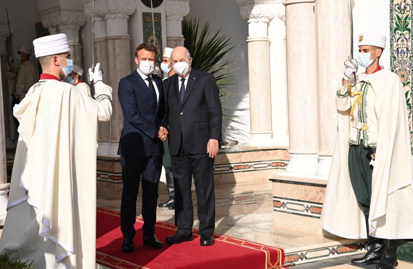  French President Emmanuel Macron shakes hand with Algerian President Abdelmadjid Tebboune at the presidential palace in Algiers, Algeria August 25, 2022 (photo credit: VIA REUTERS)