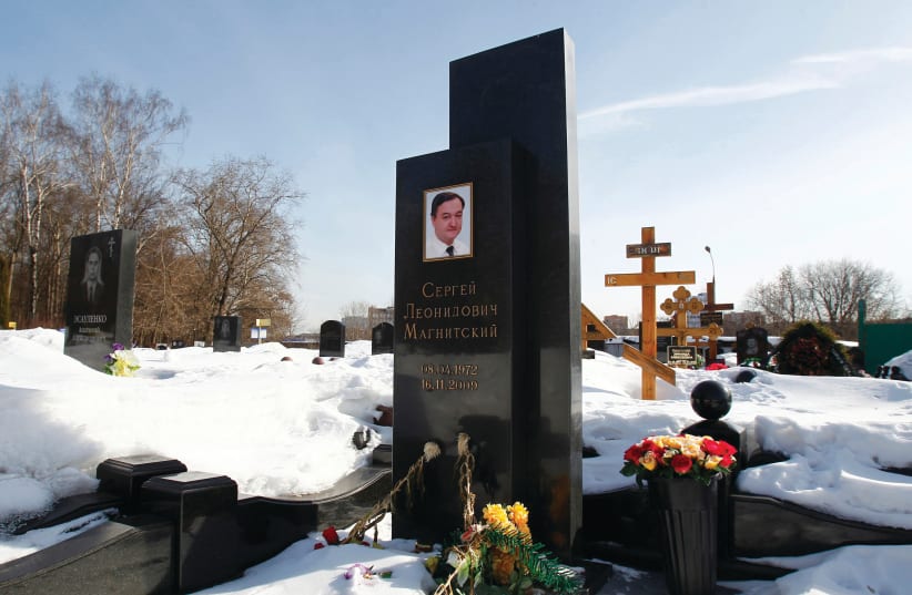  FLOWERS LIE near the grave of lawyer Sergei Magnitsky in a Moscow cemetery. (photo credit: Mikhail Voskresensky/Reuters)