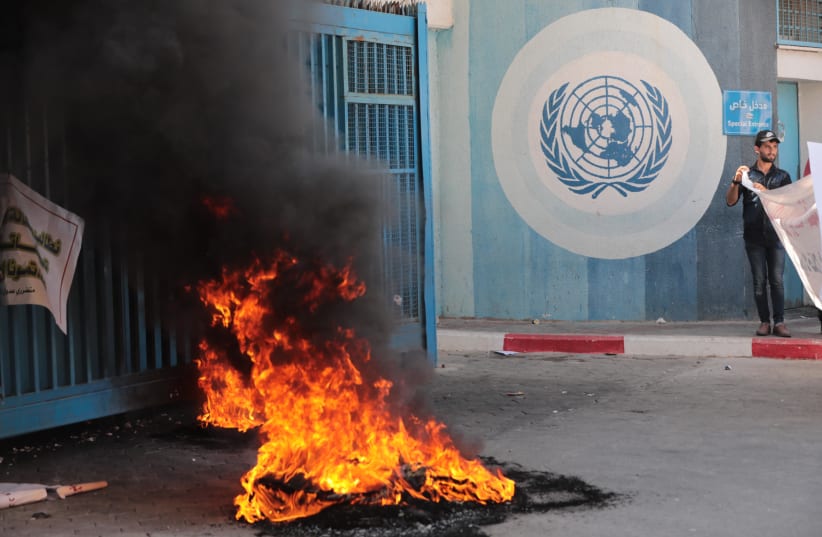  Palestinians protest demanding compensation for damaged homes in the 2014 war, outside the headquarters of UNRWA, in Gaza City, on September 5, 2022 (photo credit: ATTIA MUHAMMED/FLASH90)