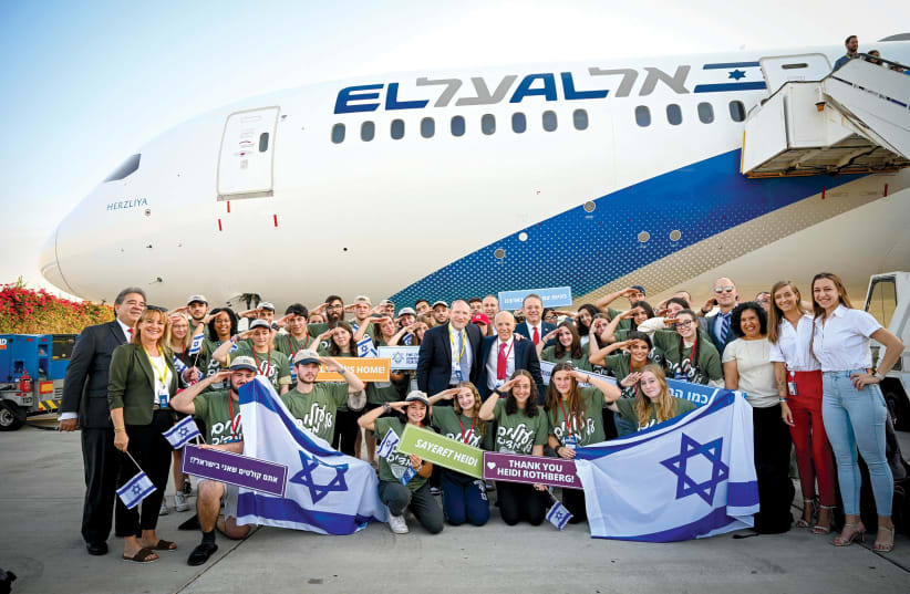  Rabbi Fass and Gelbart with partners and new immigrants at Ben-Gurion Airport, after the latest flight on August 16, 2022. (photo credit: SHAHAR AZRAN)