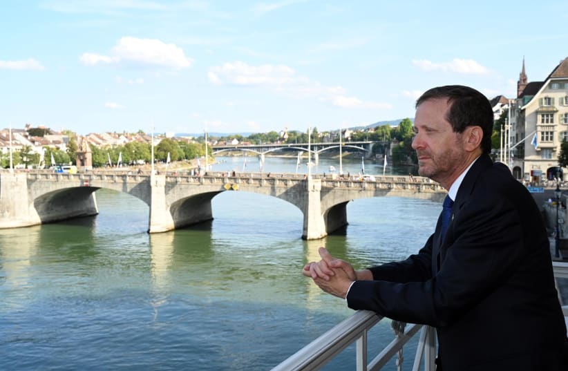  President Isaac Herzog reenacts Theodor Herzl’s famous balcony photograph in Basel on August 29, just as his late father and Israel’s sixth president, Chaim Herzog, did during his state visit to Switzerland in 1987. (photo credit: HAIM ZACH/GPO)