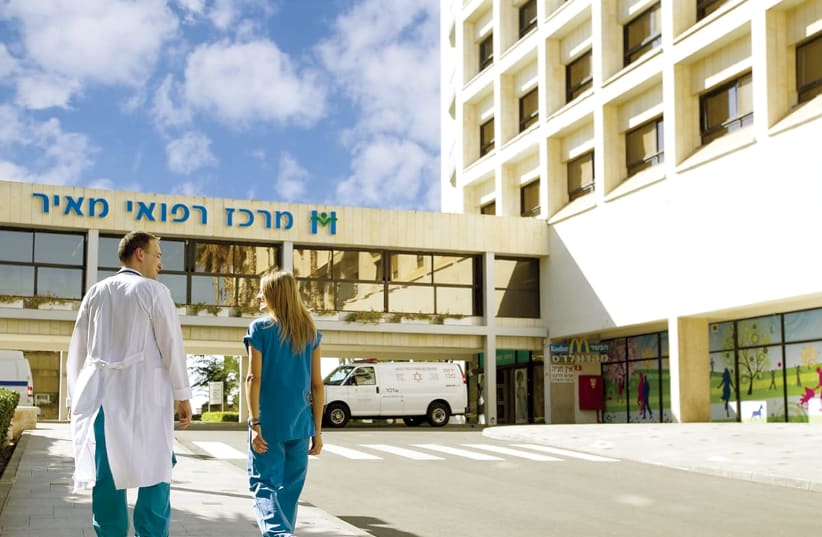  Dr. Asaf Friehmann walks with a nurse outside Meir Medical Center. (photo credit: DR. FIDA ZAHALKA)