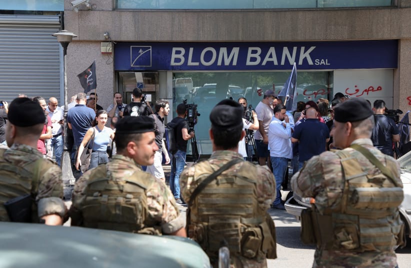  Members of the Lebanese army stand guard outside a Blom Bank branch in Beirut (photo credit: REUTERS/MOHAMED AZAKIR)