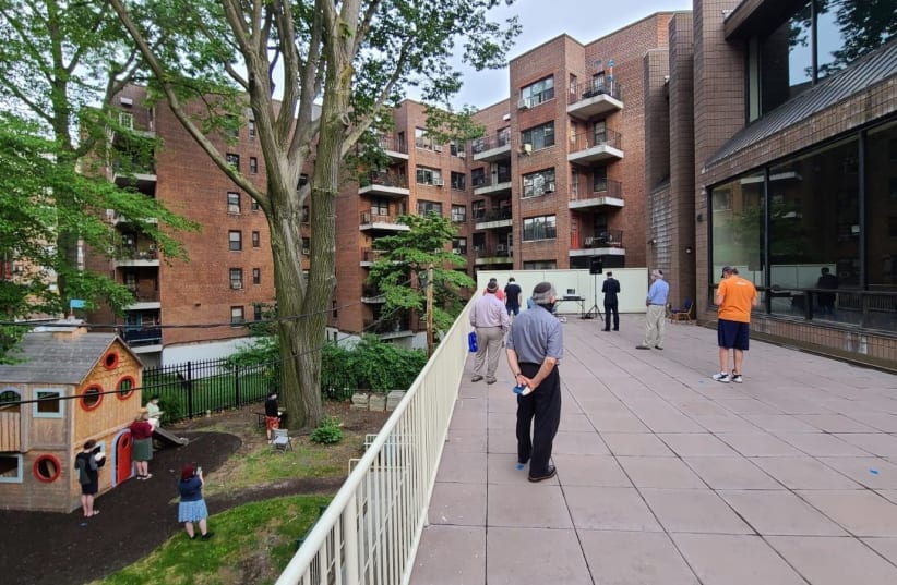  An outdoor socially distanced prayer service at at the Hebrew Institute of Riverdale in New York City, June 15, 2020 (photo credit: VIA THE MEDIA LINE)