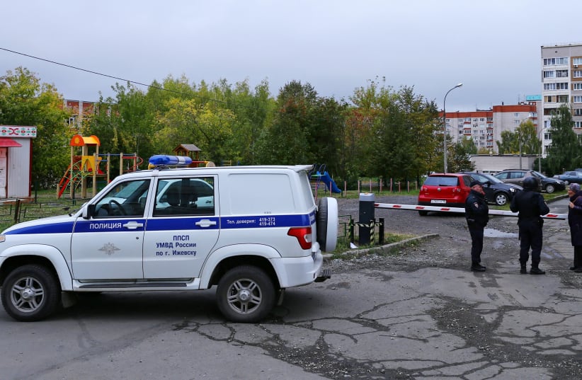  A woman talks to police officers securing area after a school shooting in Izhevsk, Russia September 26, 2022. (photo credit: REUTERS/STRINGER)