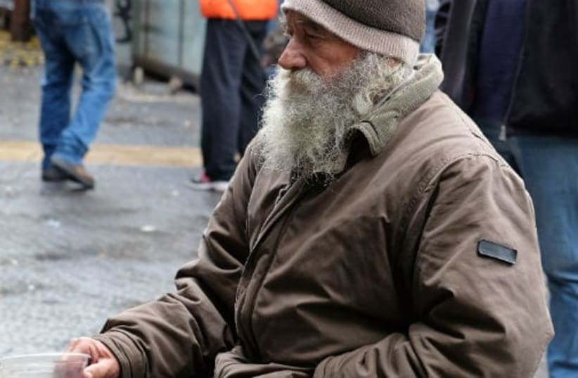  A homeless man begs on the streets. (photo credit: Lerner Vadim/Shutterstock.com)