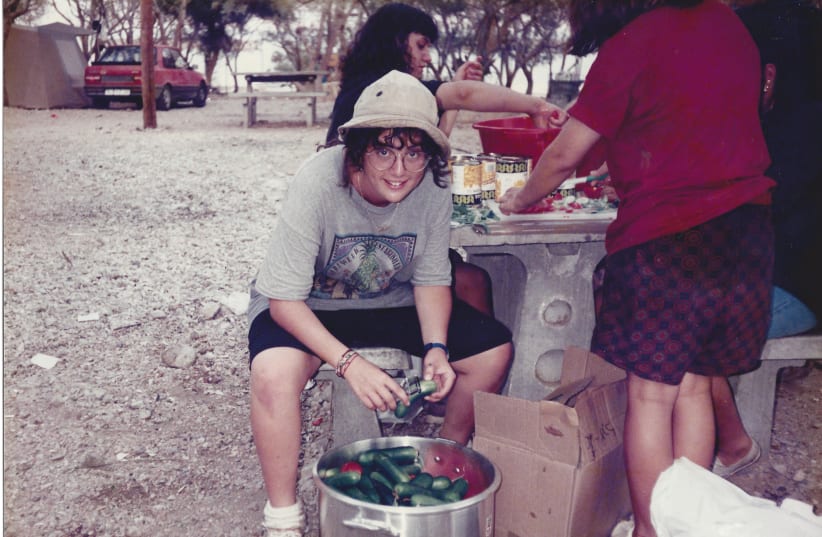  SMILING ALISA: Peeling vegetables on a summer camp trip (photo credit: Courtesy Flatow family)