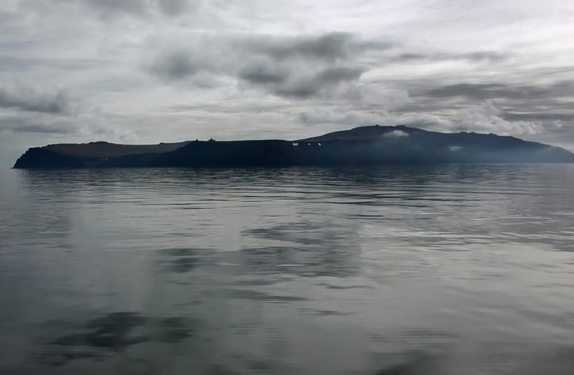  The island of Big Diomede sits in the morning mist on the Russian side of the Bering Strait as seen from the Russian research vessel Professor Khromov August 28, 2009.  (photo credit: REUTERS/Jeffrey Jones)