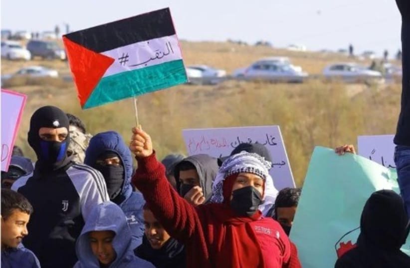  AJEEC participant waving a Palestinian flag at a demonstration. (photo credit: INSTAGRAM SCREENSHOT)