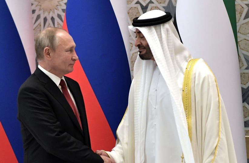Russian President Vladimir Putin and Abu Dhabi Crown Prince Mohamed bin Zayed al-Nahyan shake hands in Abu Dhabi, United Arab Emirates, October 15, 2019. (photo credit: SPUTNIK/ALEXEI NIKOLSKY/KREMLIN VIA REUTERS)