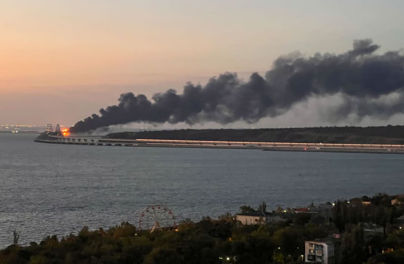  A view shows a fire on the Kerch bridge at sunrise in the Kerch Strait, Crimea, October 8, 2022.  (photo credit: REUTERS/STRINGER)