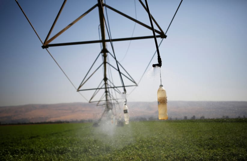  An irrigation system waters a field of crops in the Hula Valley, northern Israel (photo credit: AMIR COHEN/REUTERS)