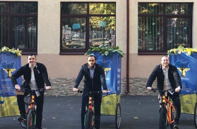  CHABAD EMISSARIES distribute gift packages and sukkot on wheels to the Jews of Ukraine. (photo credit: Courtesy)