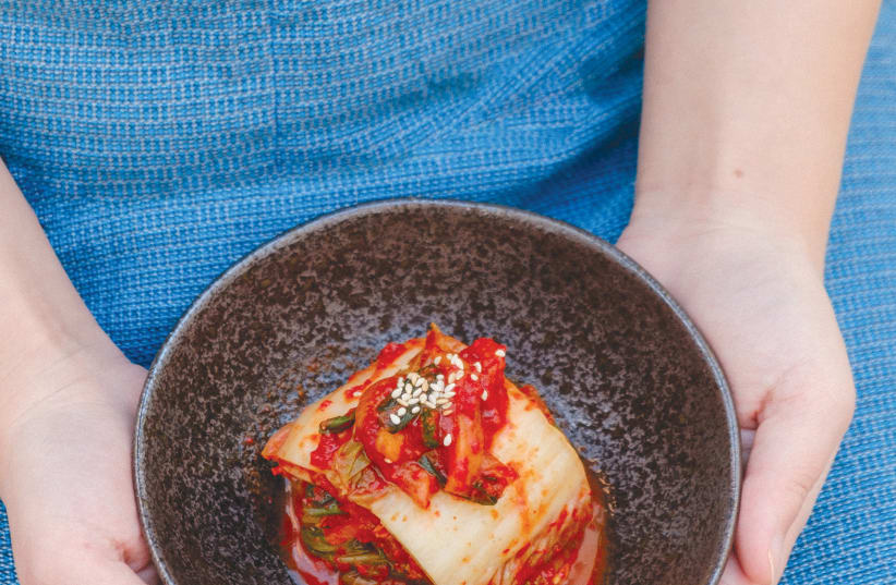  KIMCHI, A traditional Korean side dish of salted and fermented vegetables, such as napa cabbage and Korean radish (Illustrative). (photo credit: Portuguese Gravity/Unsplash)