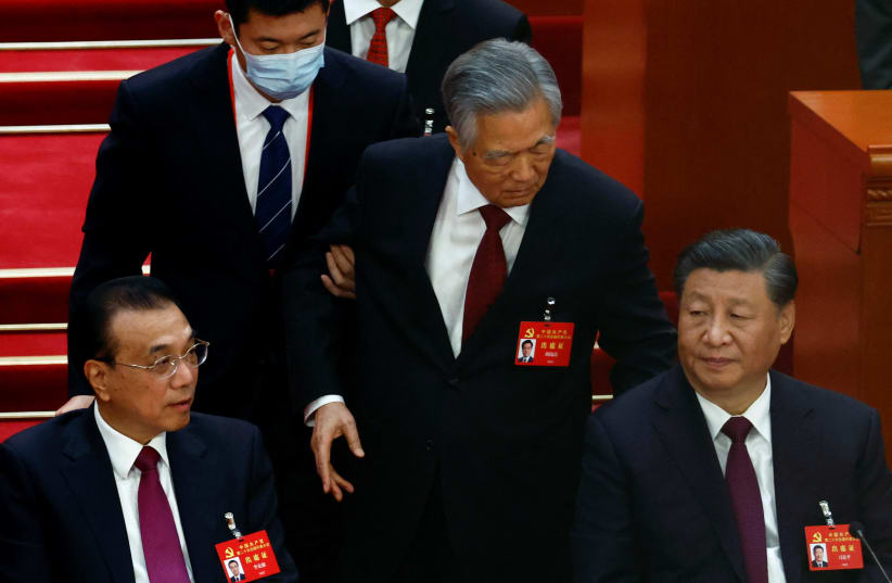  Former Chinese president Hu Jintao leaves his seat next to Chinese President Xi Jinping and Premier Li Keqiang, during the closing ceremony of the 20th National Congress of the Communist Party of China, at the Great Hall of the People in Beijing (photo credit: REUTERS)