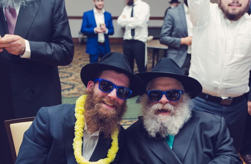 FOR US ‘children of Rav Rodal,’ life became one big song: With son Yossi at his wedding. (photo credit: Yossi Percia)